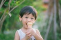 Asia boy he mouth aftertaste from eating chocolate ice cream or chocolate dessert. A sweet-toothed child eat chocolate. Kid with