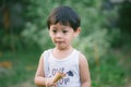 Asia boy he mouth aftertaste from eating chocolate ice cream or chocolate dessert. A sweet-toothed child eat chocolate. Kid with