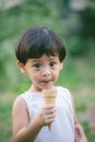 Asia boy he mouth aftertaste from eating chocolate ice cream or chocolate dessert. A sweet-toothed child eat chocolate. Kid with