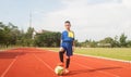 Asia boy playing Soccer football field stadium. Royalty Free Stock Photo