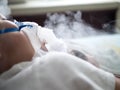 Asia boy sleeping on bed while making inhalation with nebulizer mask at the hospital Royalty Free Stock Photo