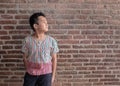 Asia boy stand front wall brick old age Royalty Free Stock Photo
