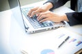 Asia business woman analyzing investment charts on desk.