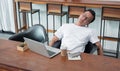 asia casual man sit back feel tired from work at laptop in coffee shop,stress business concept,work outside office,work at home.