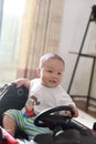 Asia Chinese adorable naughty cute toddler infant baby boy son smile grin drive toy car sunny day in Summer maternal love family Royalty Free Stock Photo