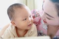 Asia Chinese Mom toddler baby boy son read book indoor home teaching early education lying on bed maternal love family Royalty Free Stock Photo