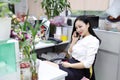 Asia Chinese office lady woman girl on chair make a call use desk phone chat work smile wear business occupation suit workplace Royalty Free Stock Photo