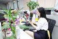 Asia Chinese office lady woman girl on chair make a call use desk phone chat work smile wear business occupation suit workplace Royalty Free Stock Photo