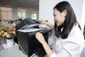 Asia Chinese office lady woman girl print copy paper use printer copier at work smile wear business occupation suit workplace