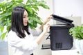 Asia Chinese office lady woman girl printing material use printer at work smile wear business occupation suit workplace