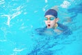 Asia cute boy wearing swimming suit and goggles used foam to practice swimming in swimming pool. Healthy kid enjoying active Royalty Free Stock Photo