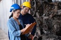 Asia engineer woman standing with man at the automotive engine part in the factory. Worker holding clipboard and checking list Royalty Free Stock Photo