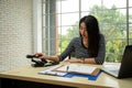 Asia female person hand holding using old telephone calling on desk in office