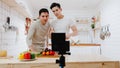 Asia gay couple blogger vlogger and online influencer recording video content on healthy food in kitchen at home. Young LGBT men Royalty Free Stock Photo