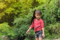 Asia Girl child in Red T-shirt looks down