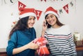 Asia girl friends wear santa hat in merry christmas party and ex Royalty Free Stock Photo