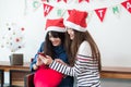 Asia girl friends wear santa hat in merry christmas party using Royalty Free Stock Photo