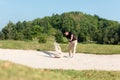 Asia Golfer man hitting out of a sand trap. The golf course is on the sand Royalty Free Stock Photo