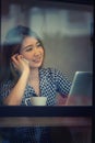 Asia happy woman talking phone in cafe and enjoying coffee Royalty Free Stock Photo