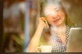 Asia happy woman talking phone in cafe and enjoying coffee Royalty Free Stock Photo