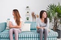 Asia lesbian lgbt couple quarrel sitting each side of sofa with Royalty Free Stock Photo