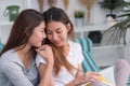 Asia lesbian lgbt couple sitting on sofa reading book and hug to