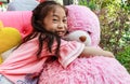 Asia little girl hug doll bear in restaurant Royalty Free Stock Photo