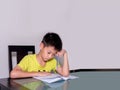 Asia little student boy studying and doing his homework at home Royalty Free Stock Photo