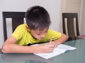 Asia little student boy studying and doing his homework Royalty Free Stock Photo