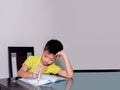 Asia little student boy studying and doing his homework at home Royalty Free Stock Photo