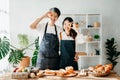 Asia lovers or couples cooking in kitchen with full of ingredient with Bread and fruiton table.Valentines day Royalty Free Stock Photo