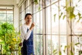 Asia man holding cup coffee and standing near window coffee break time