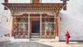 The asia man monk walks near the main door tower prayer at Paro Dzong,