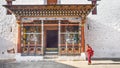 The asia man monk walks near the main door tower prayer at Paro Dzong,