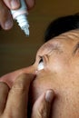 Asia man use medicine eyedropper Royalty Free Stock Photo