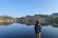 asia men traveller looking out at village reflection lake standing and chill out at ban rak thai Mae Hong Son