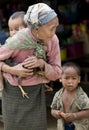 Asia, old woman with chicken and grandson Royalty Free Stock Photo