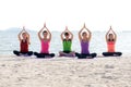 Asia people group making warrior pose on beach, fitness, sport, yoga and healthy lifestyle. Royalty Free Stock Photo