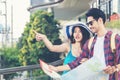 Asia people tourist man and women sightseeing city with map.  Lifestyle traveler looking and pointing at Bangkok urban, Royalty Free Stock Photo