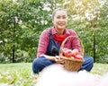 Asia senior woman holding red apple at public park. Royalty Free Stock Photo