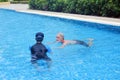 Portrait asia senior woman and caucasian old man resting together in the edge of swimming pool in clubhouse Royalty Free Stock Photo