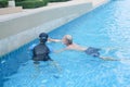 Portrait asia senior woman and caucasian old man resting together in the edge of swimming pool in clubhouse Royalty Free Stock Photo