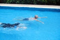 Portrait asia senior woman and caucasian old man resting together in the edge of swimming pool in clubhouse Royalty Free Stock Photo