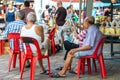 Asia / Singapore - Nov 9, 2019 : Group of ages mature adult Asian men relaxing in outdoor weekend, reading newspaper passing time