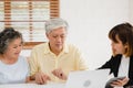 Asia smart female agent offers health insurance for elderly couples by document, tablet and laptop. Aged Asian couple consulting Royalty Free Stock Photo