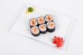 Asia. Spicy rolls with salmon red fish on a white plate on a w