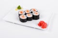 Asia. Spicy rolls with salmon red fish on a white plate on a w