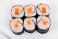 Asia. Spicy rolls with salmon red fish on a white plate on a w