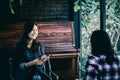 Asia teenage hipster in happiness with cellphone and friend in cafe