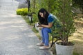 Asia thai woman travel visit and sitting on bench posing for take photo in public garden park Royalty Free Stock Photo